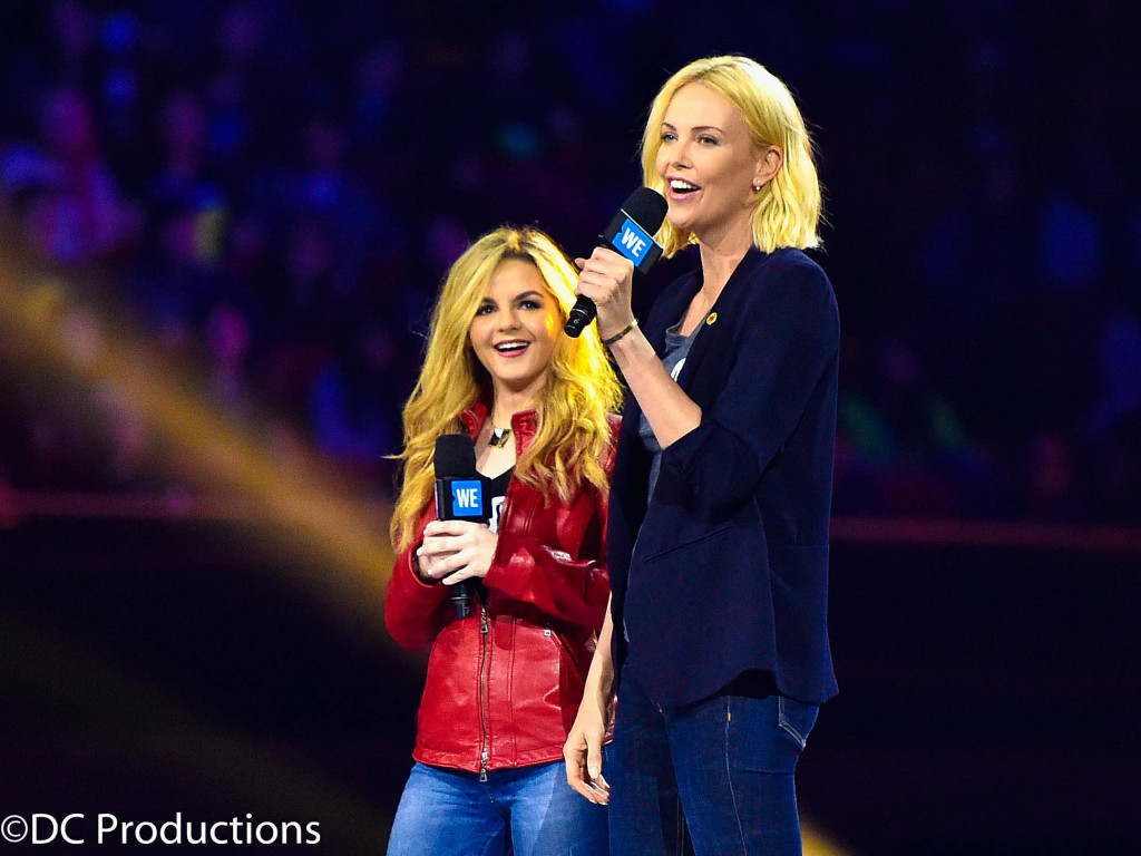 "INGLEWOOD, CA - APRIL 07: Activist Ashley Murphy (L) and actress Charlize Theron speak onstage at WE Day California 2016 at The Forum on April 7, 2016 in Inglewood, California. (Photo by Mike Windle/Getty Images for WE Day)"