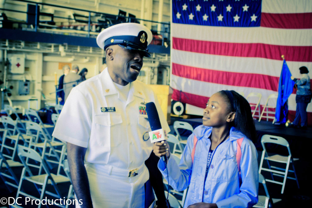 Thandi Chirwa interviews Navy Personnel during the U.S Navy Immigration naturalization ceremony media ceoverage